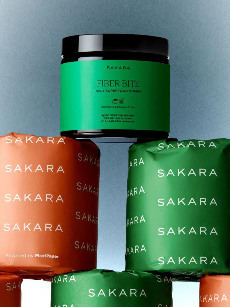 Sakara Fiber Bite stacked on top of sakara-branded toilet paper rolls